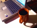 Photo of laptop and cup of coffee